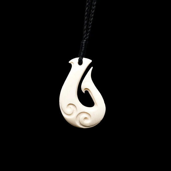 carved fishing hook of whale bone Hand Fish Tail Necklace & Paua Shell Inlay Earthbound Pacific Black Cord This Hawaiian Fish Hook with Whales Tail is expertly crafted from Buffalo Bone and carved with intricate engravings on one side of the pendant Matau (fish hook) Taonga. 1800